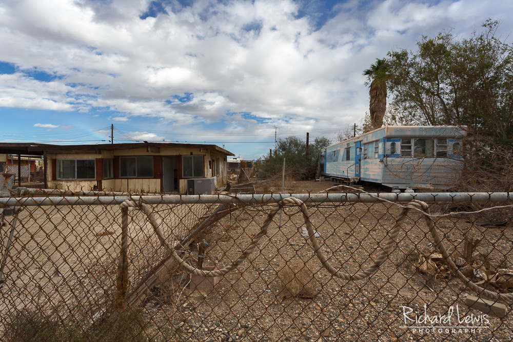 Abandoned House And Trailer With Rainbow In Bombay Beach